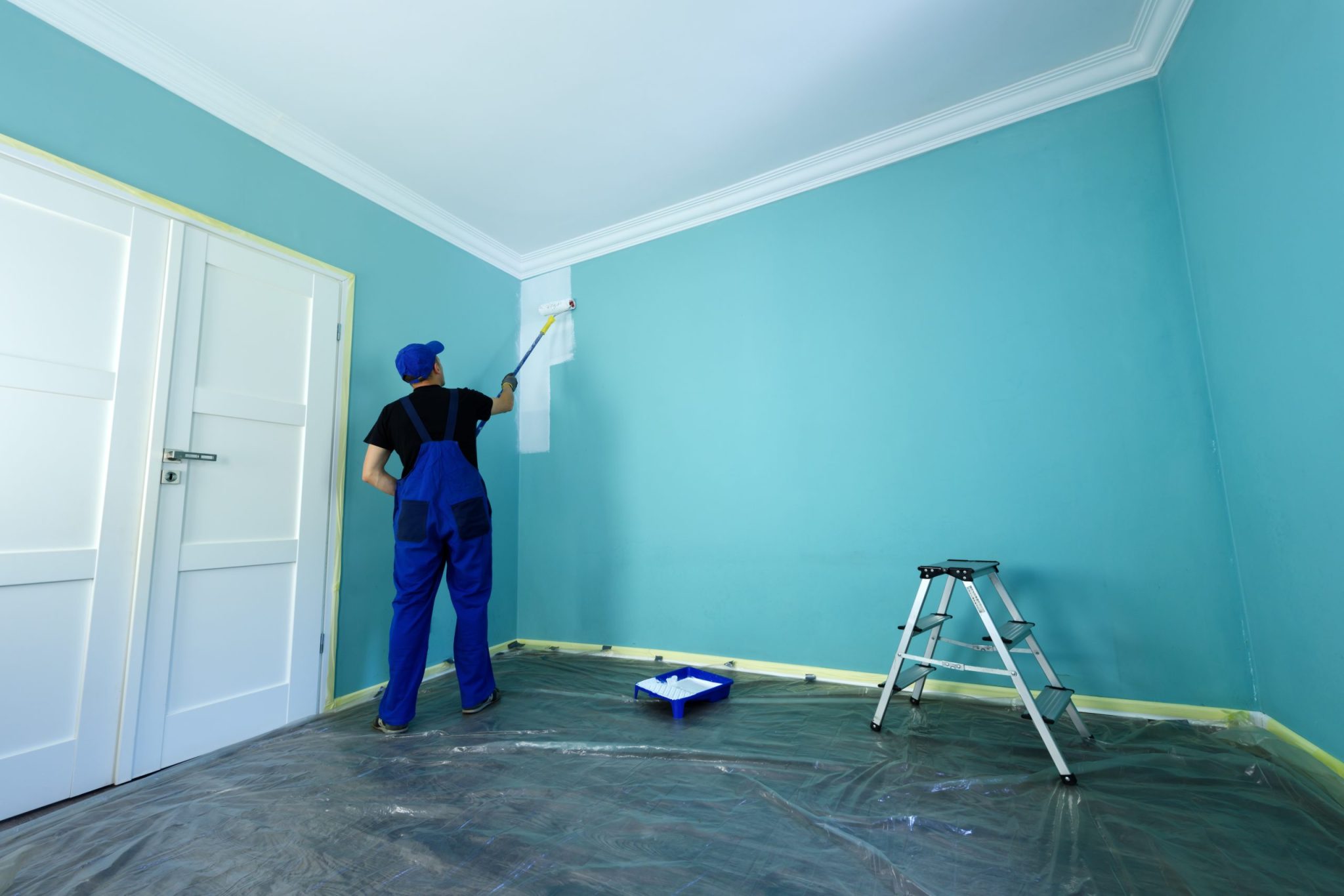 Blue Coast Professional Painting painter painting the wall of a home.